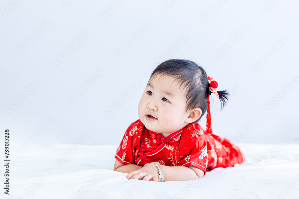 Chinese New Year concept, cute happy little girl in Chinese dress sitting in white living room. Cute Asian baby sitting in white living room, Chinese New Year concept Chinese New Year concept, cute happy little girl in Chinese dress sitting in white living room. Cute Asian baby sitting in white living room, Chinese New Year concept