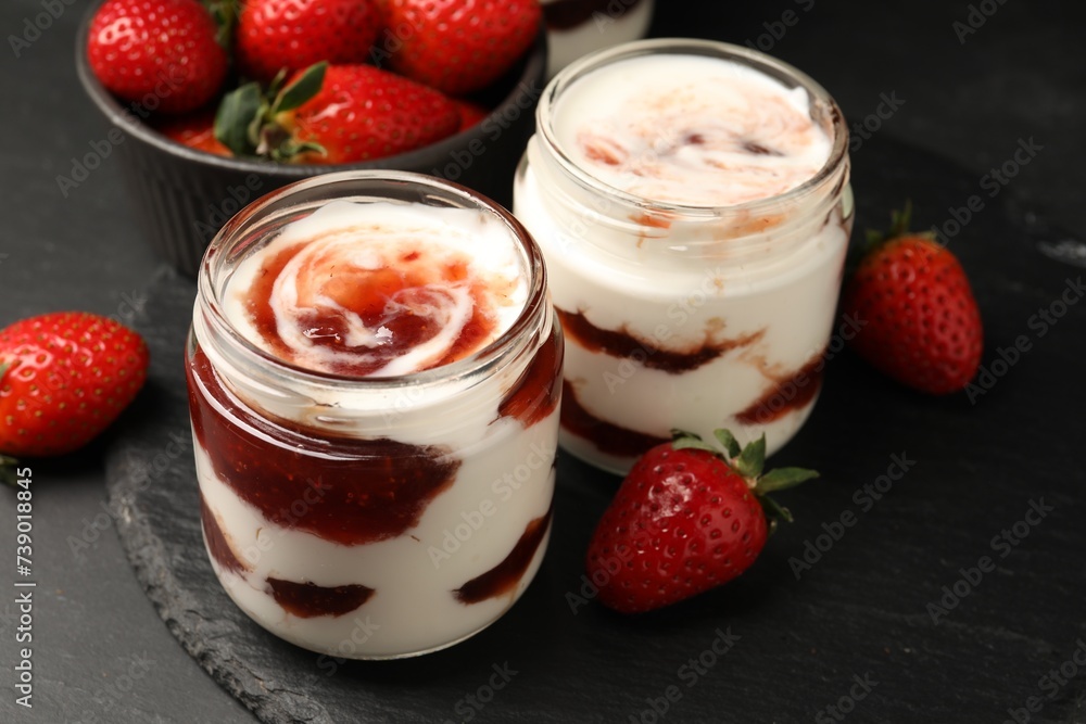 Tasty yoghurt with jam and strawberries on black table, closeup Tasty yoghurt with jam and strawberries on black table, closeup
