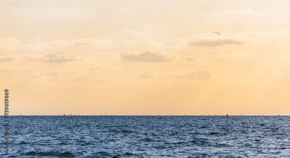 Fototapeta premium Orange sunset landscape over the blue sea.