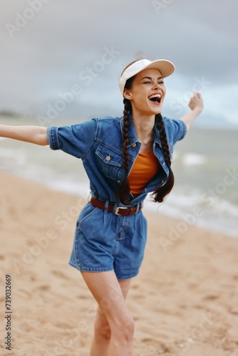 Happy Young Woman Enjoying Carefree Summer Vacation on a Beautiful Beach © SHOTPRIME STUDIO