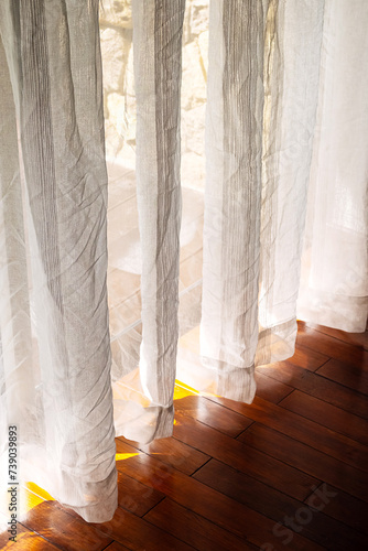 Sunlight shining through the curtains, close up.