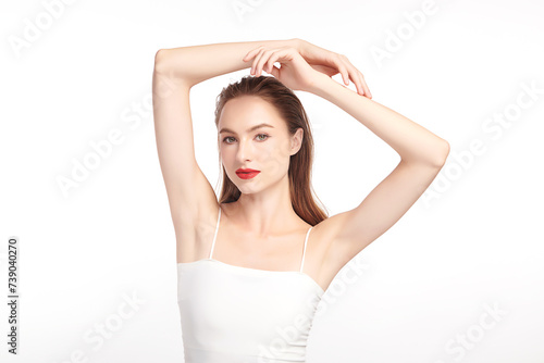 Beautiful Young woman lifting hands up to show off clean and hygienic armpits or underarms on white background, Smooth armpit cleanliness and protection concept