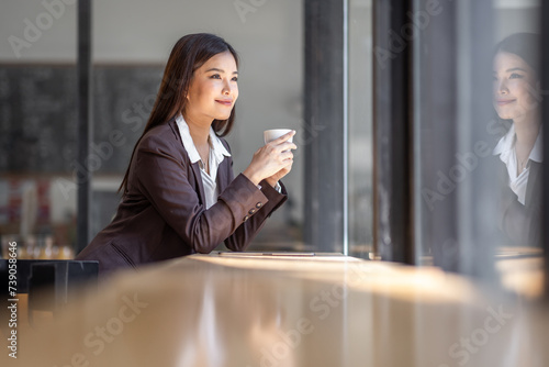 Portrait of Smiling and beautiful millennial Asian businesswoman having coffee in the coffee shop. lifestyle concept