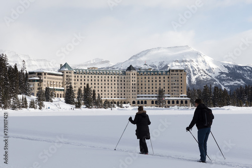 Chateau Lake Louise hotel in front of half frozen lake Louise - Banff , Alberta, Canada. photo