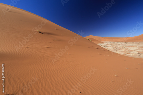 red desert sand dunes with steel blue sky