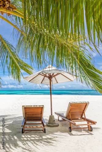 Beautiful tropical beach leisure banner. Couple chairs umbrella white sand coco palm trees travel honeymoon wide panorama background. Amazing landscape. Luxury island resort vacation  sunshine sea sky