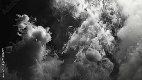 Transparent smoke shapes against black background photo
