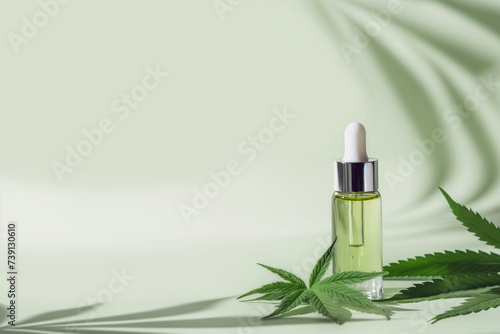 CBD Hemp oil in a dropper bottle. Cannabis oil with Marijuana plants around. Medical marijuana green leaves, alternative medicine. Oil extracts in a bottle, natural treatment, cosmetic component.