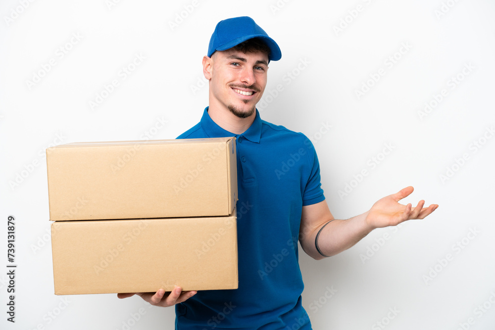 Delivery caucasian man isolated on white background extending hands to the side for inviting to come Delivery caucasian man isolated on white background extending hands to the side for inviting to come