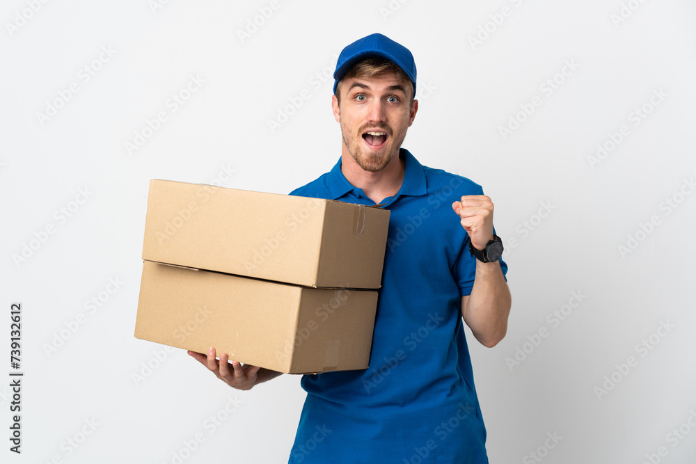 Young delivery blonde man isolated on white background celebrating a victory in winner position Young delivery blonde man isolated on white background celebrating a victory in winner position