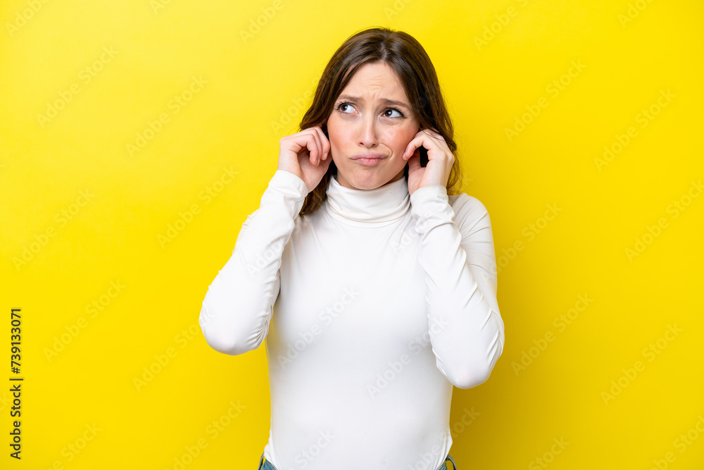 Young caucasian woman isolated on yellow background frustrated and covering ears Young caucasian woman isolated on yellow background frustrated and covering ears