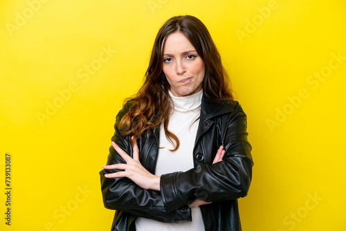 Young caucasian woman isolated on yellow background with unhappy expression photo