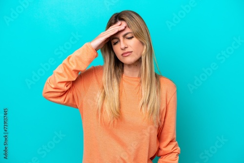 Young Uruguayan woman isolated on blue background with headache