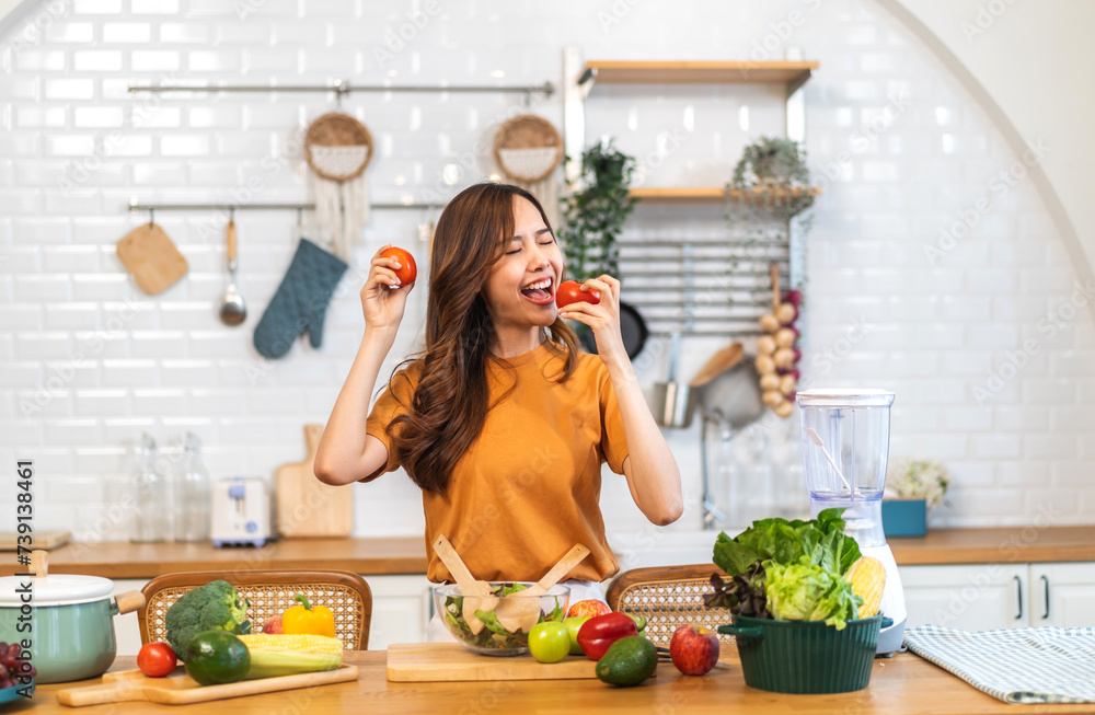 Portrait of beauty health asian woman having fun hold tomato cooking, vegan food healthy eat, fresh vegetable, Lycopene, vitamins, skincare, vegetarian in kitchen.Diet.Fitness, healthy food Portrait of beauty health asian woman having fun hold tomato cooking, vegan food healthy eat, fresh vegetable, Lycopene, vitamins, skincare, vegetarian in kitchen.Diet.Fitness, healthy food