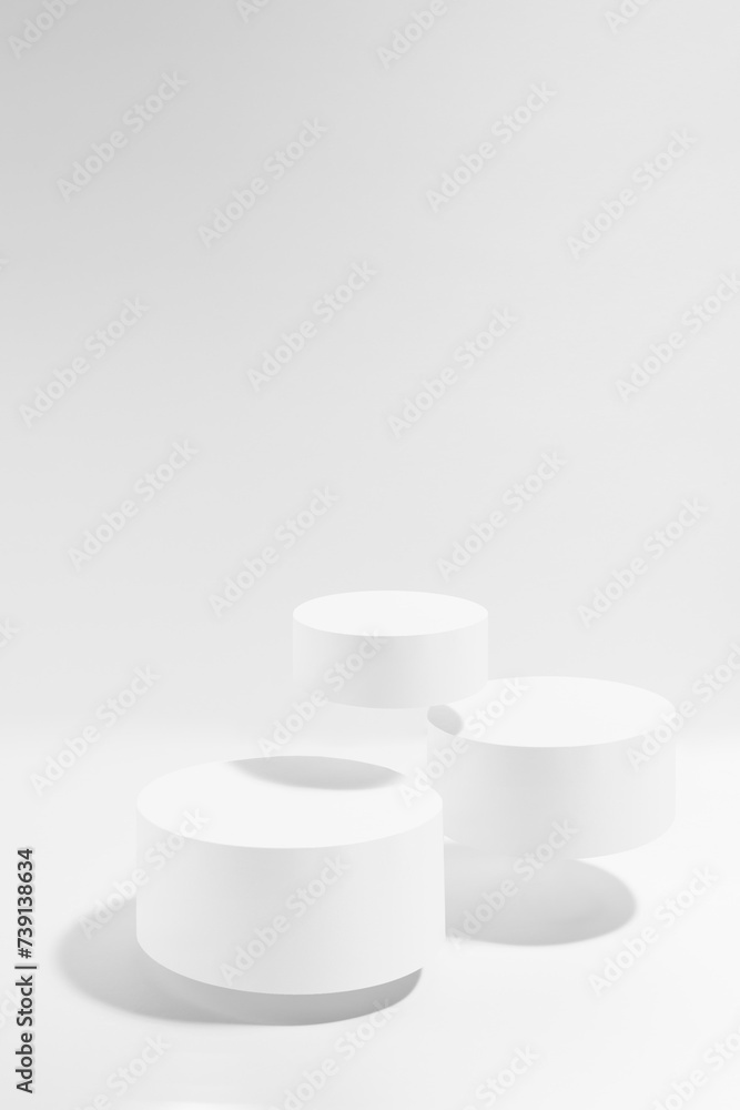 Three white round podiums soar in hard light, set, mockup on white background. Template for presentation cosmetic products, gifts, goods, advertising, design, display, showing in black friday style. Three white round podiums soar in hard light, set, mockup on white background. Template for presentation cosmetic products, gifts, goods, advertising, design, display, showing in black friday style.