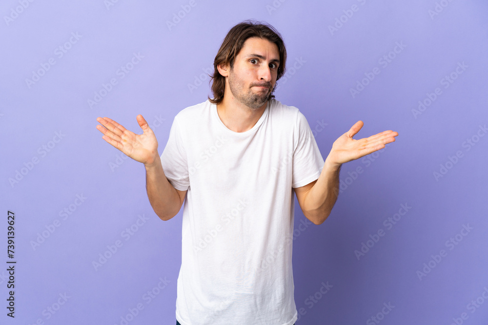 Young handsome man isolated on purple background making doubts gesture Young handsome man isolated on purple background making doubts gesture