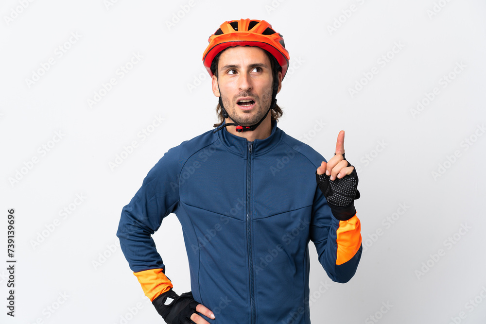 Young cyclist man isolated on white background thinking an idea pointing the finger up - obrazy, fototapety, plakaty 