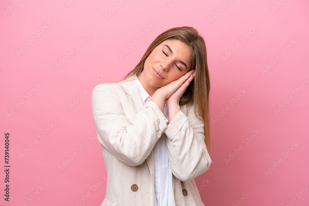 Young caucasian woman isolated on pink bakcground making sleep gesture in dorable expression Young caucasian woman isolated on pink bakcground making sleep gesture in dorable expression