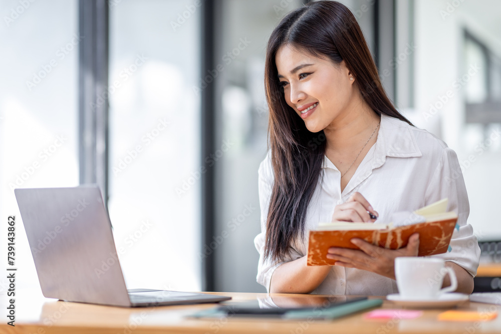 Asian Businesswoman Using laptop computer and working at office with calculator document on desk, doing planning analyzing the financial report, business plan investment, finance analysis concept.
Asian Businesswoman Using laptop computer and working at office with calculator document on desk, doing planning analyzing the financial report, business plan investment, finance analysis concept.