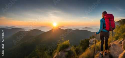 Young women hiker looking sunset at top of the mountain. goals concept. success concept. photo