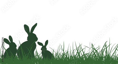 Vector silhouette of a rabbit on a meadow. Easter background.