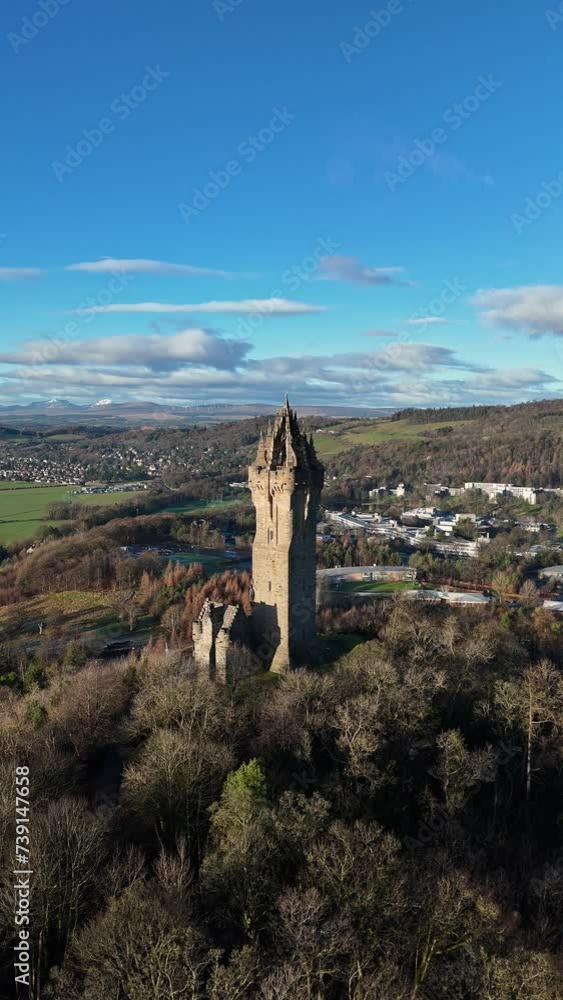 Vertical drone shot of the National Wallace Monument on a sunny day in Stirling city, Scotland, UK Vertical drone shot of the National Wallace Monument on a sunny day in Stirling city, Scotland, UK
