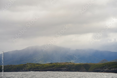 clouds over mountains over the water in a national park and beautiful rock mountain above the ocean in a national park