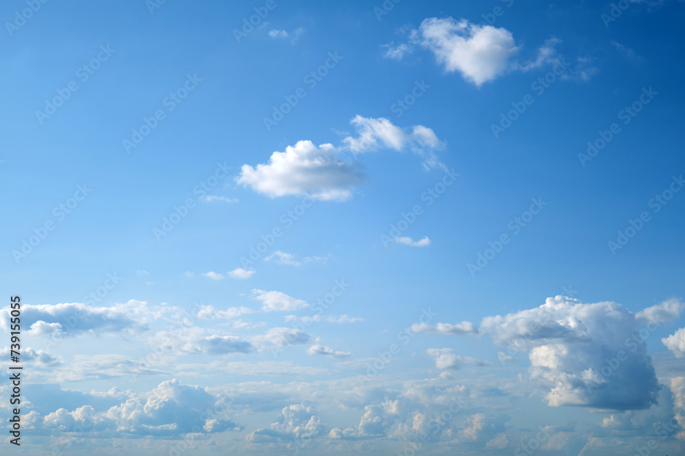 Blue sky background with white clouds. Cumulus white clouds in the blue sky. Blue sky background with white clouds. Cumulus white clouds in the blue sky.