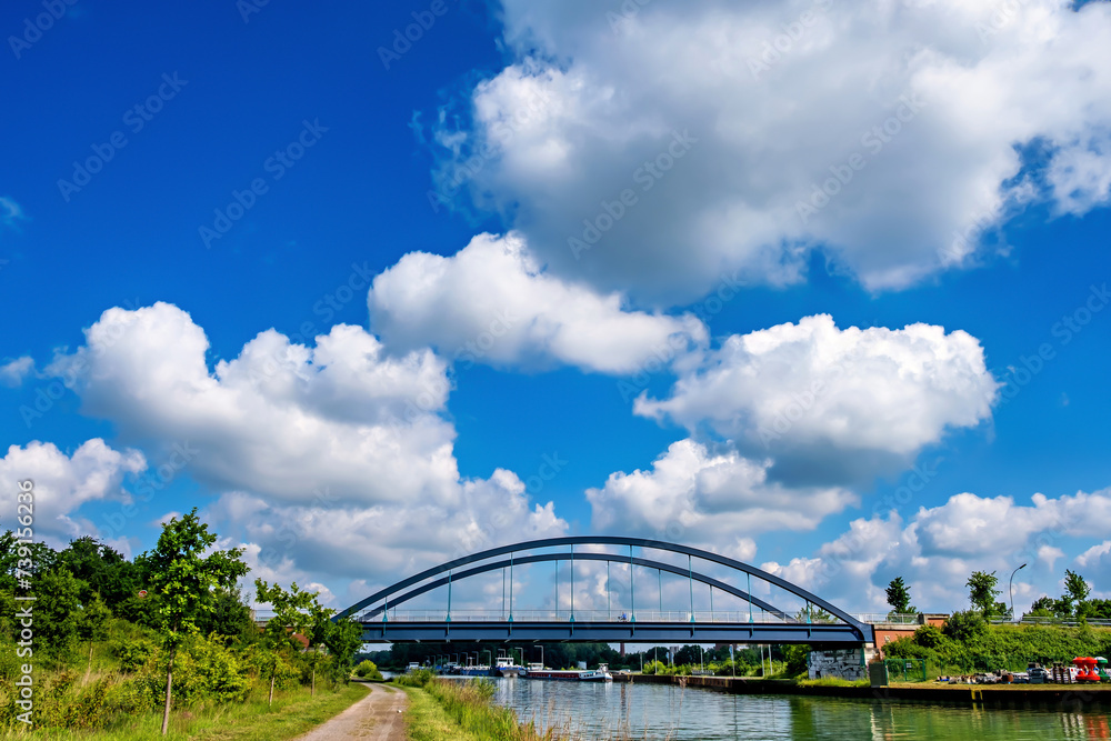Bridge over canal and white clouds