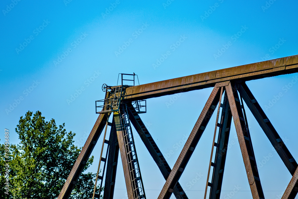 Old wooden railroad bridge against the blue sky Old wooden railroad bridge against the blue sky