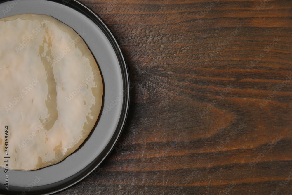 Making kombucha. Scoby fungus on wooden table, top view. Space for text Making kombucha. Scoby fungus on wooden table, top view. Space for text