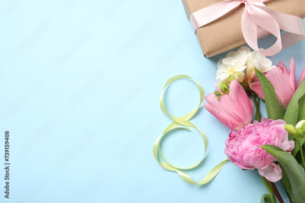 8th of March greeting card design with green ribbon, present, beautiful flowers and space for text on light blue background, flat lay. International Women's day 8th of March greeting card design with green ribbon, present, beautiful flowers and space for text on light blue background, flat lay. International Women's day