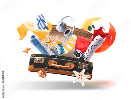 Flying open suitcase and beach accessories