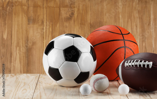 Many different sports balls on wooden background, space for text