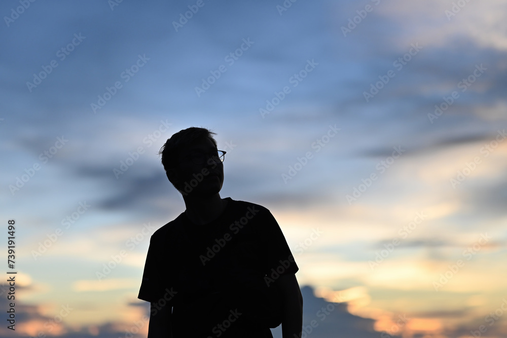 Silhouette of a man with eyeglasses looking on the sky on the mountain, Solo travel concept Silhouette of a man with eyeglasses looking on the sky on the mountain, Solo travel concept