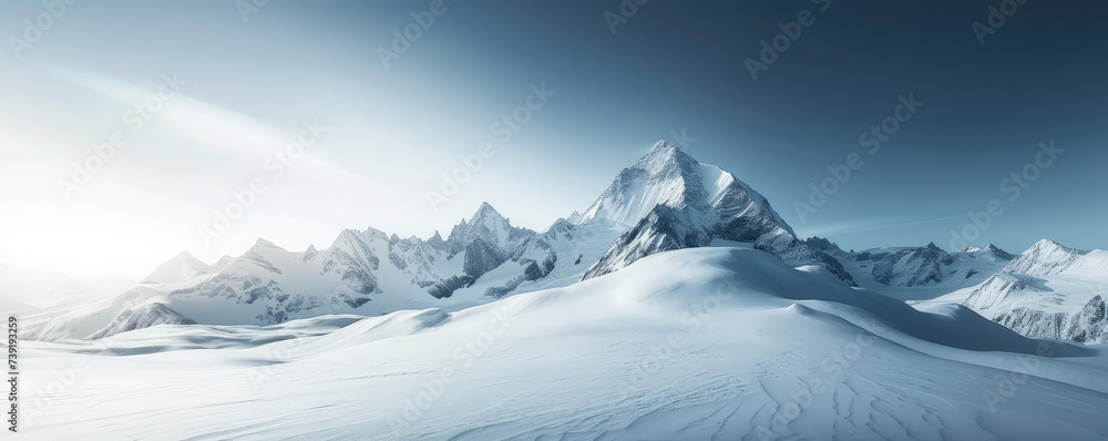 Snow-Capped Mountain Peak. Majestic snow covered winter mountain peak under a clear blue sky background with copy space.