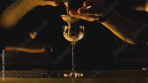 Bartender makes elegant cocktail tonight photo