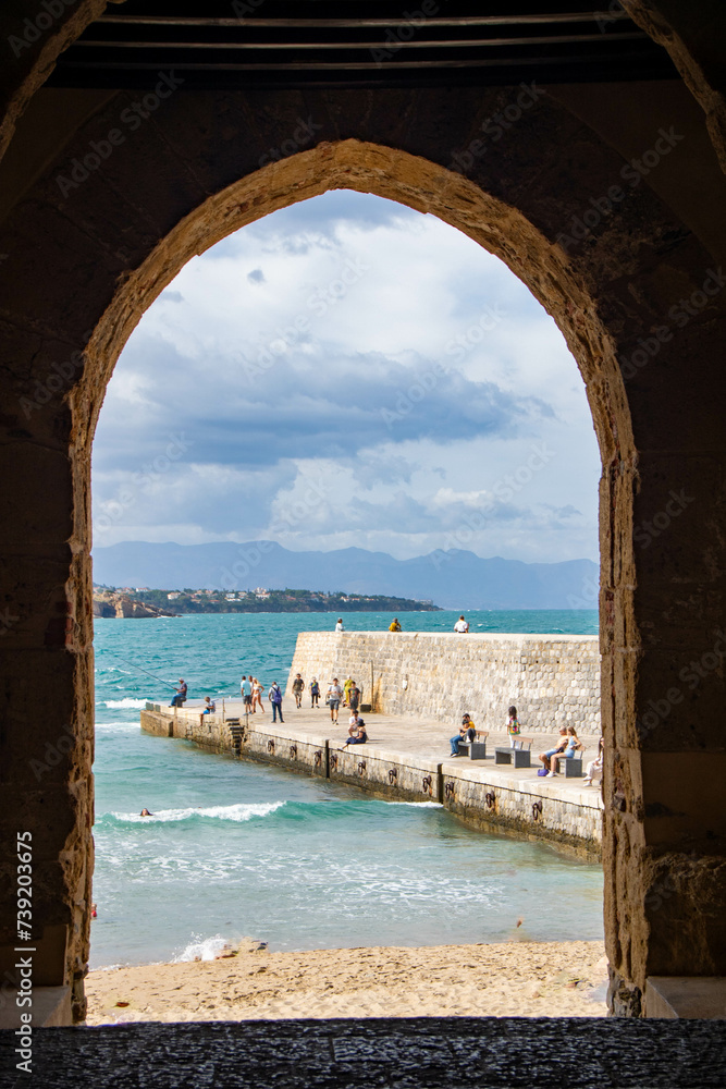view through an arch of the coastline at Cefalu