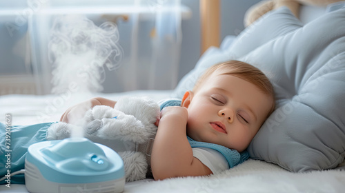 Little cute baby is sleeping soundly and the air humidifier is working in the room. photo