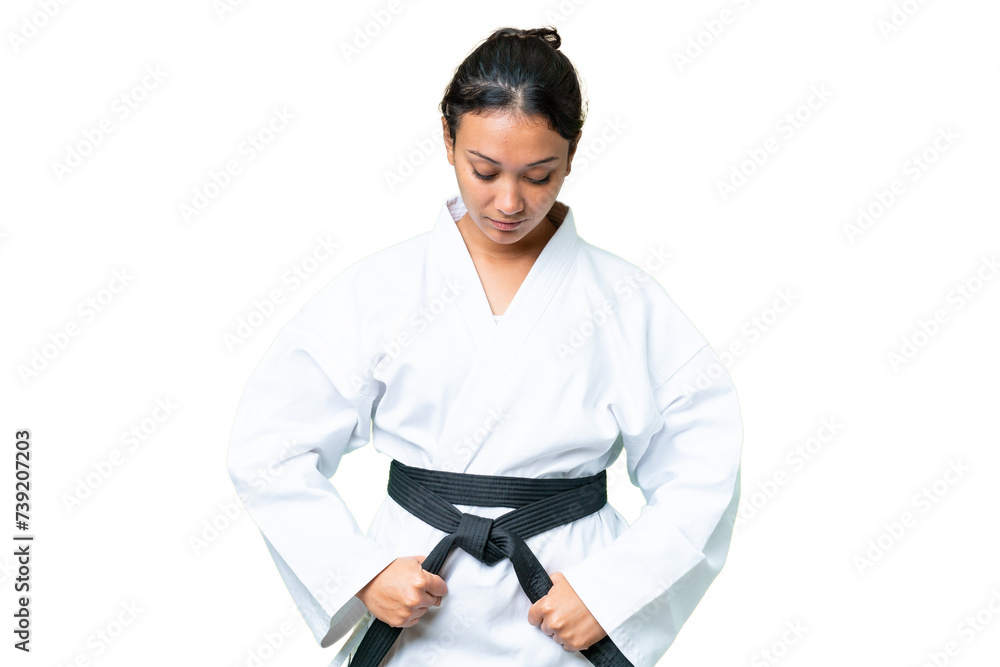 Young Uruguayan woman over isolated chroma key background doing karate Young Uruguayan woman over isolated chroma key background doing karate