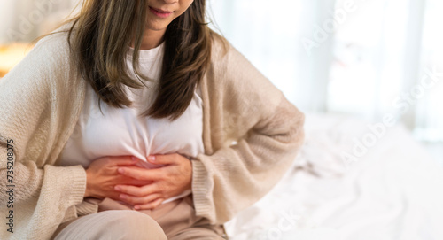 Tableau sur toile Woman sick unhappy holding belly stomach with suffering from stomach ache pain, monthly period, gastritis, gastroenteritis, food poisoning, diarrhea, intestinal inflammation, Woman healthcare