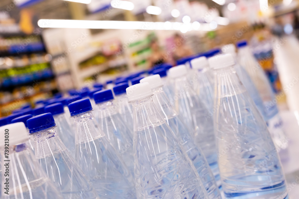 Water bottles with blue caps in supermarket Water bottles with blue caps in supermarket