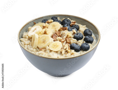 Tasty oatmeal with banana, blueberries, milk and walnuts in bowl isolated on white