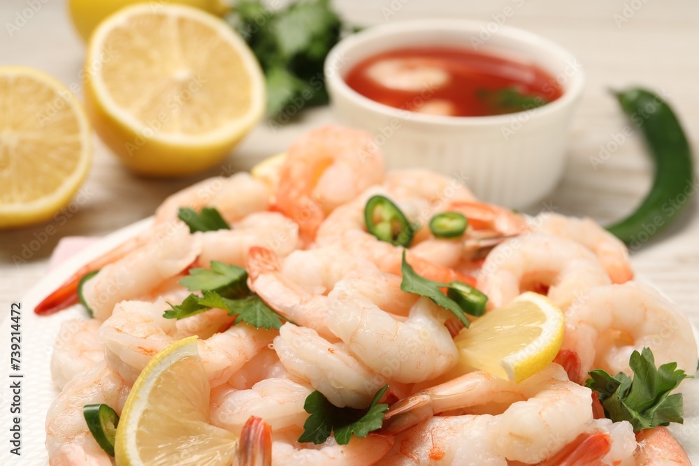 Tasty boiled shrimps with cocktail sauce, chili and parsley on table, closeup Tasty boiled shrimps with cocktail sauce, chili and parsley on table, closeup