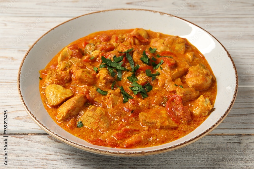 Delicious chicken curry on wooden table, closeup Delicious chicken curry on wooden table, closeup