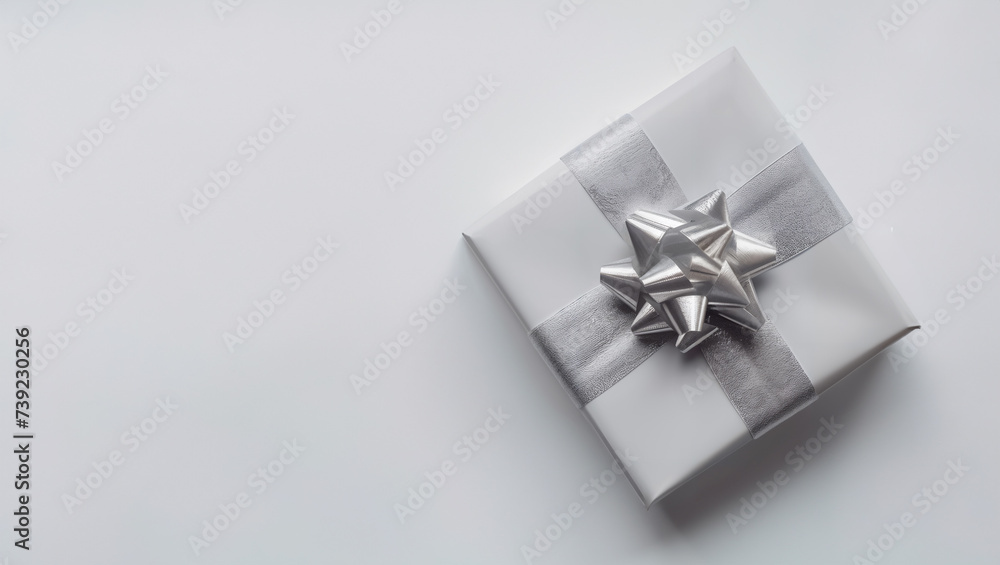 White gift box with a silver ribbon on a white background, place to copy own text White gift box with a silver ribbon on a white background, place to copy own text