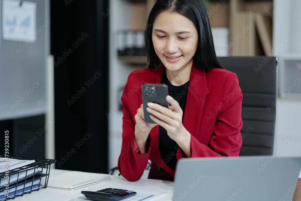 Business woman are using smalrtphone and Laptop to work.. Business woman are using smalrtphone and Laptop to work..