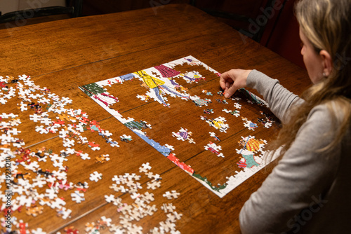 Woman doing a jigsaw puzzle photo