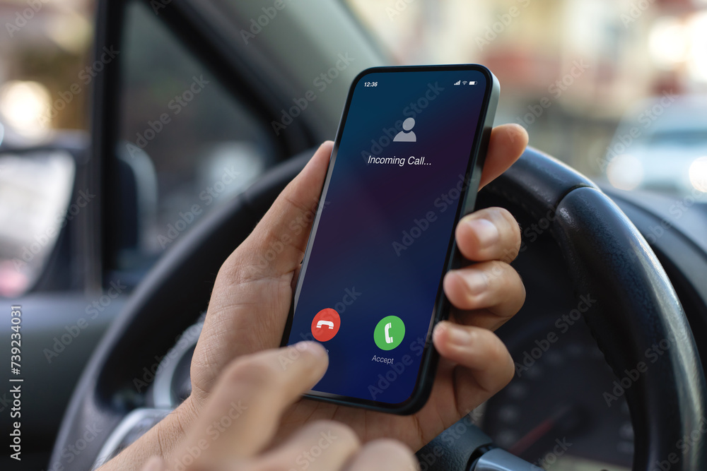 Man hand hold phone incoming call background steering wheel car