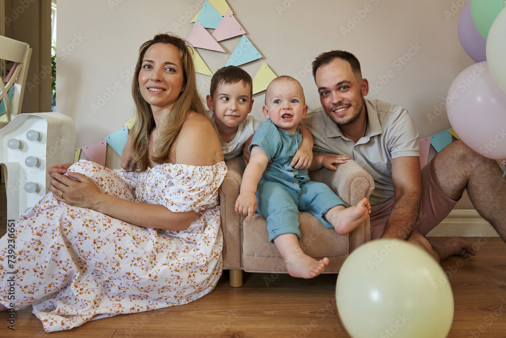 Adorable one-year-old boy surrounded by love and laughter on his first birthday. Adorable one-year-old boy surrounded by love and laughter on his first birthday.